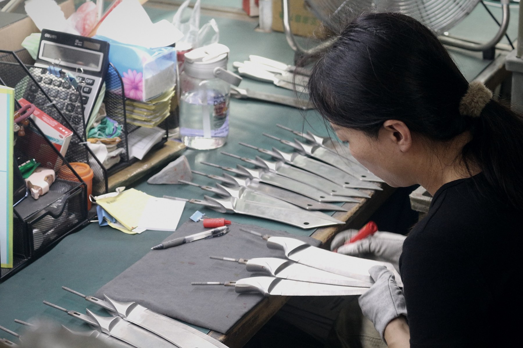 Finished knives checked and marked one by one at the inspection bench