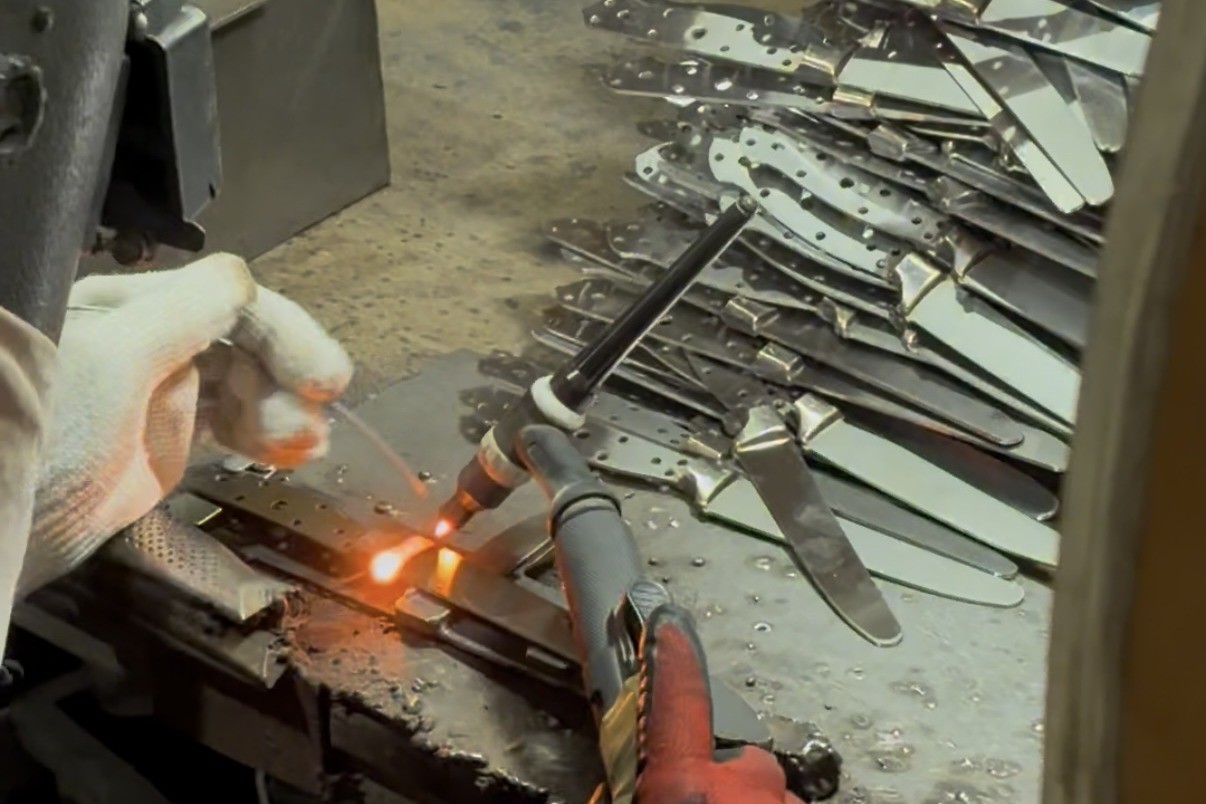 Flame brazing the bolster to the blade